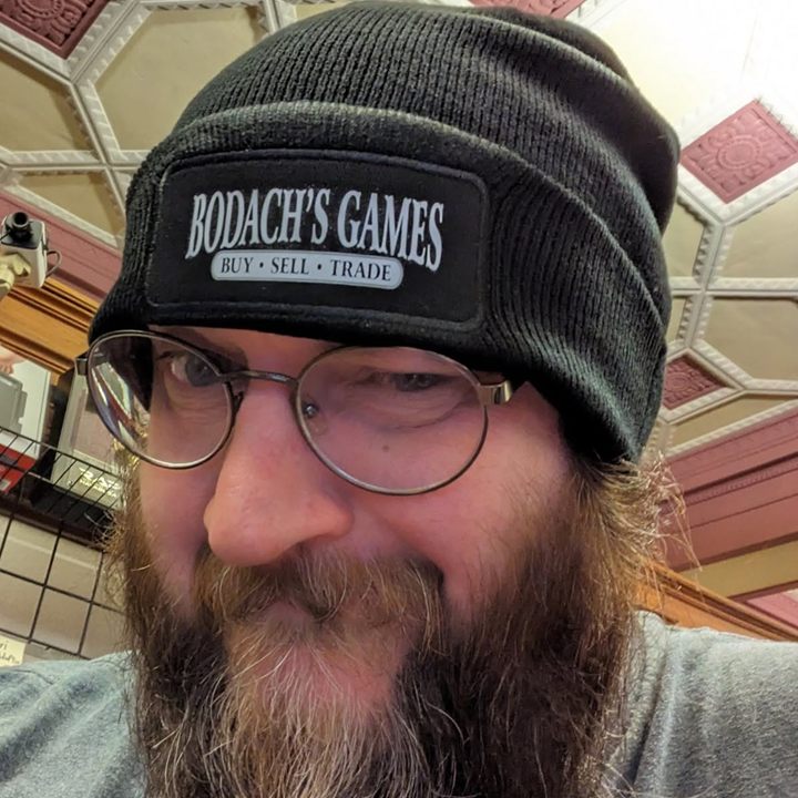 John, better known as Bodach, in a Bodach's Games beanie under the bank's ornate ceiling