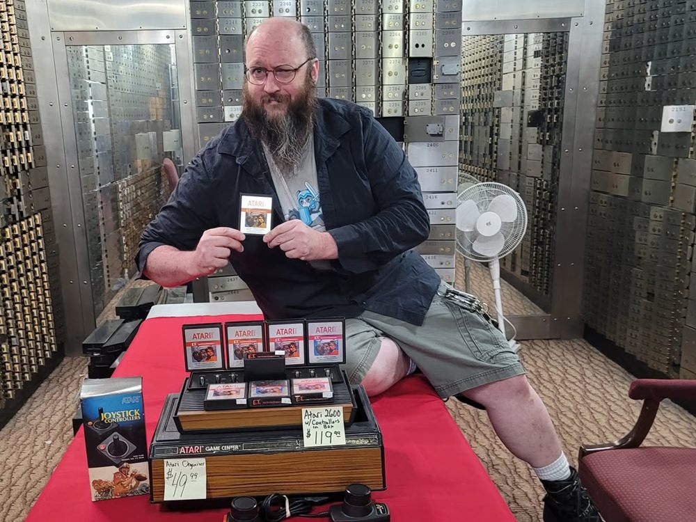 Bodach holding an Atari E.T. cartridge next to a boxed Atari 2600 in the vault